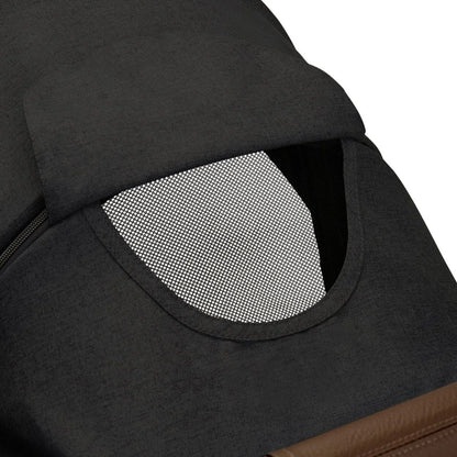 Close-up of a black pet carrier with a mesh window on a white background